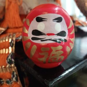 daruma japonés rojo con kanji dorado