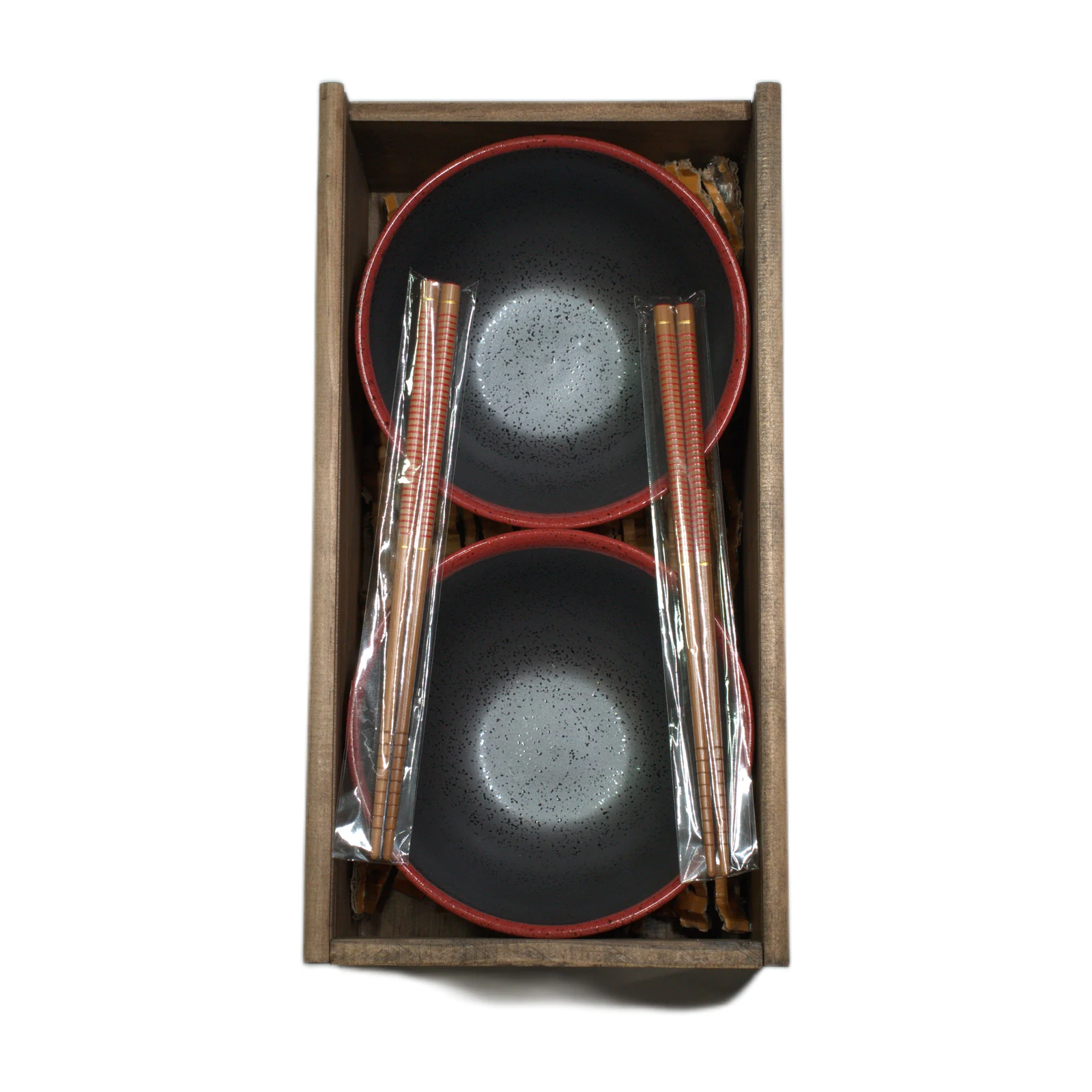 Dos cuencos con borde rojo y dos pares de palillos en caja de madera